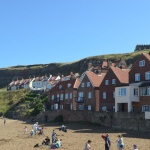 Cottages overlooking beach and harbour at Whitby
