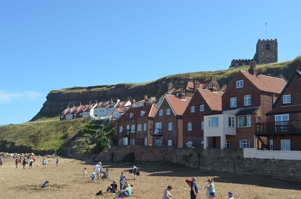 Cottages overlooking beach and harbour at Whitby